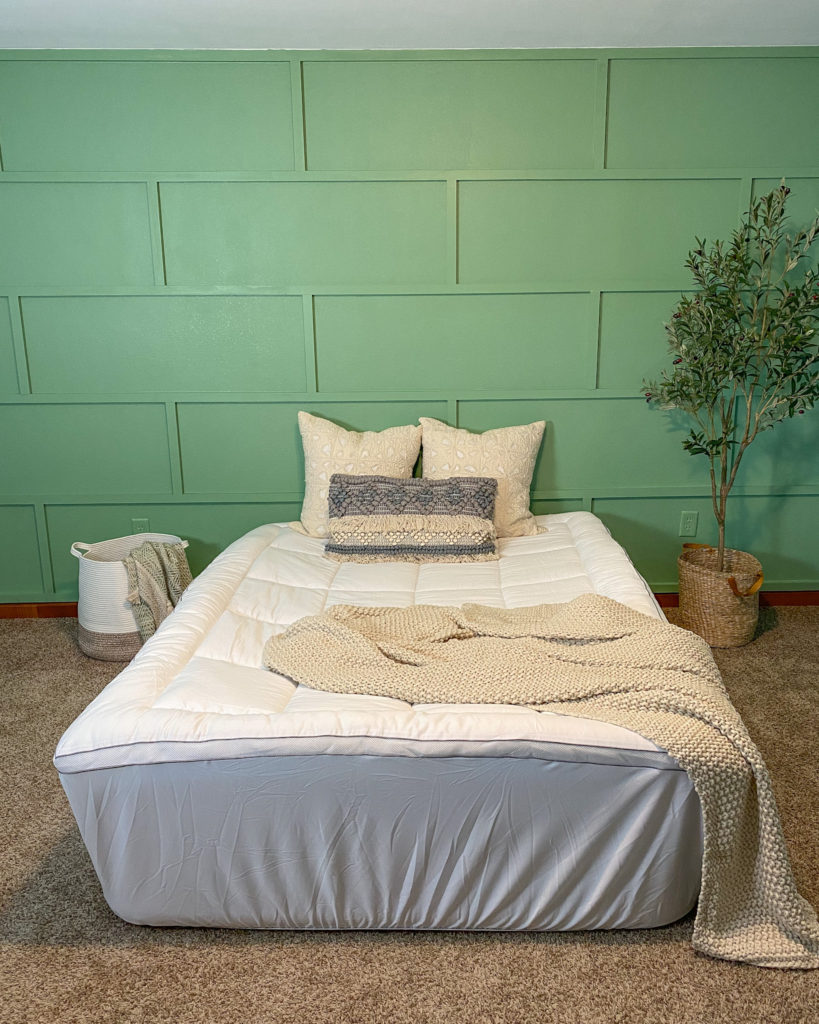 Mattress topper on air mattress in guest bedroom with modern accent wall