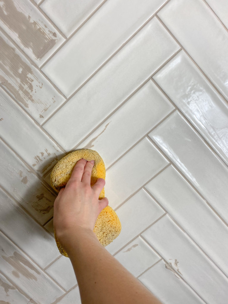 Wiping off grout with a sponge
