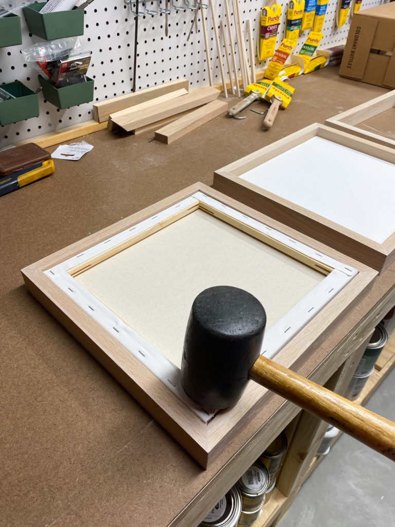 Tapping canvases into frames for modern wall art