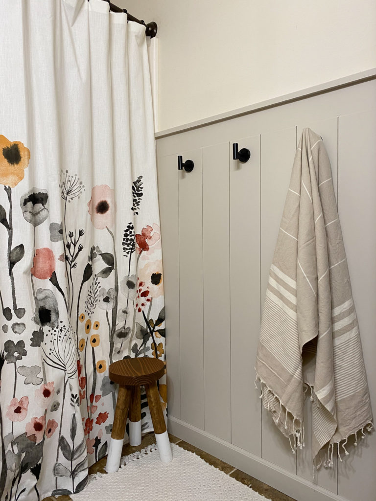 Finished Vertical Shiplap Wall in Bathroom with Floral Curtain