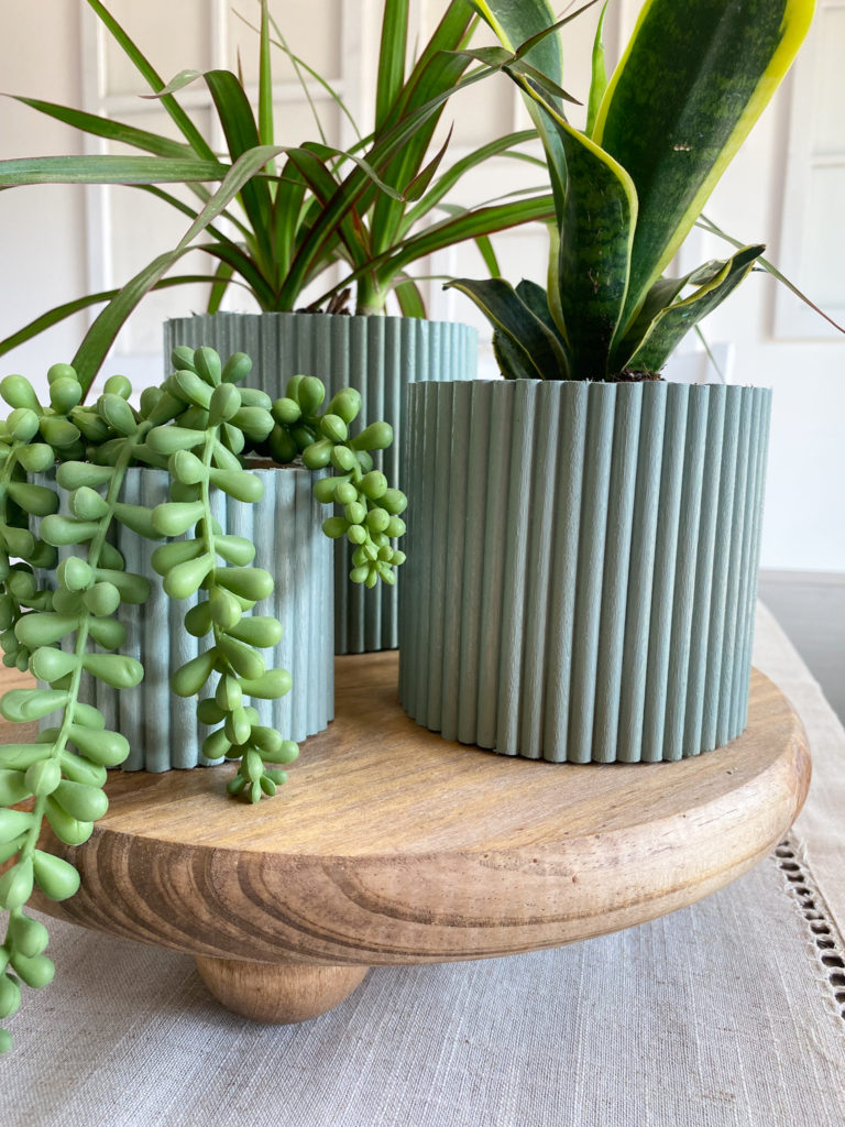 Up close view of plant riser and DIY dowel planters
