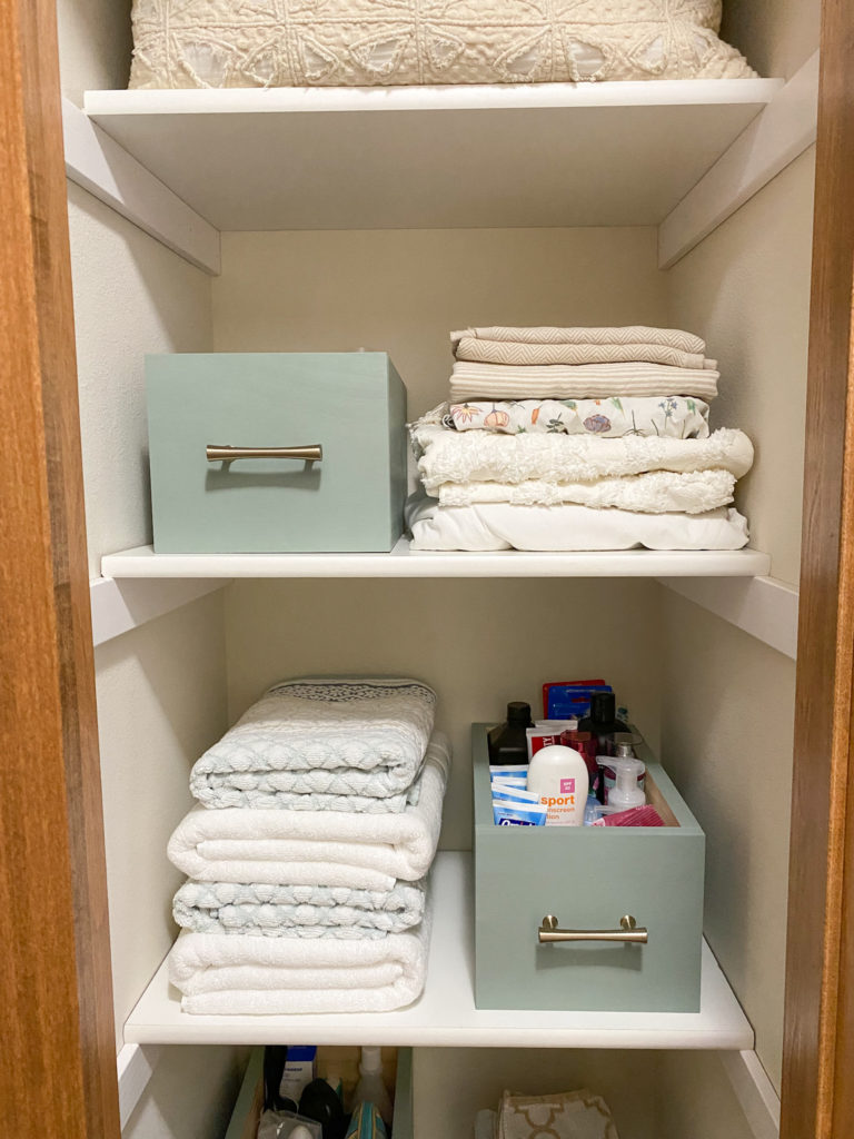 Final Linen Closet Organization Project featuring beautiful wood containers for medicine
